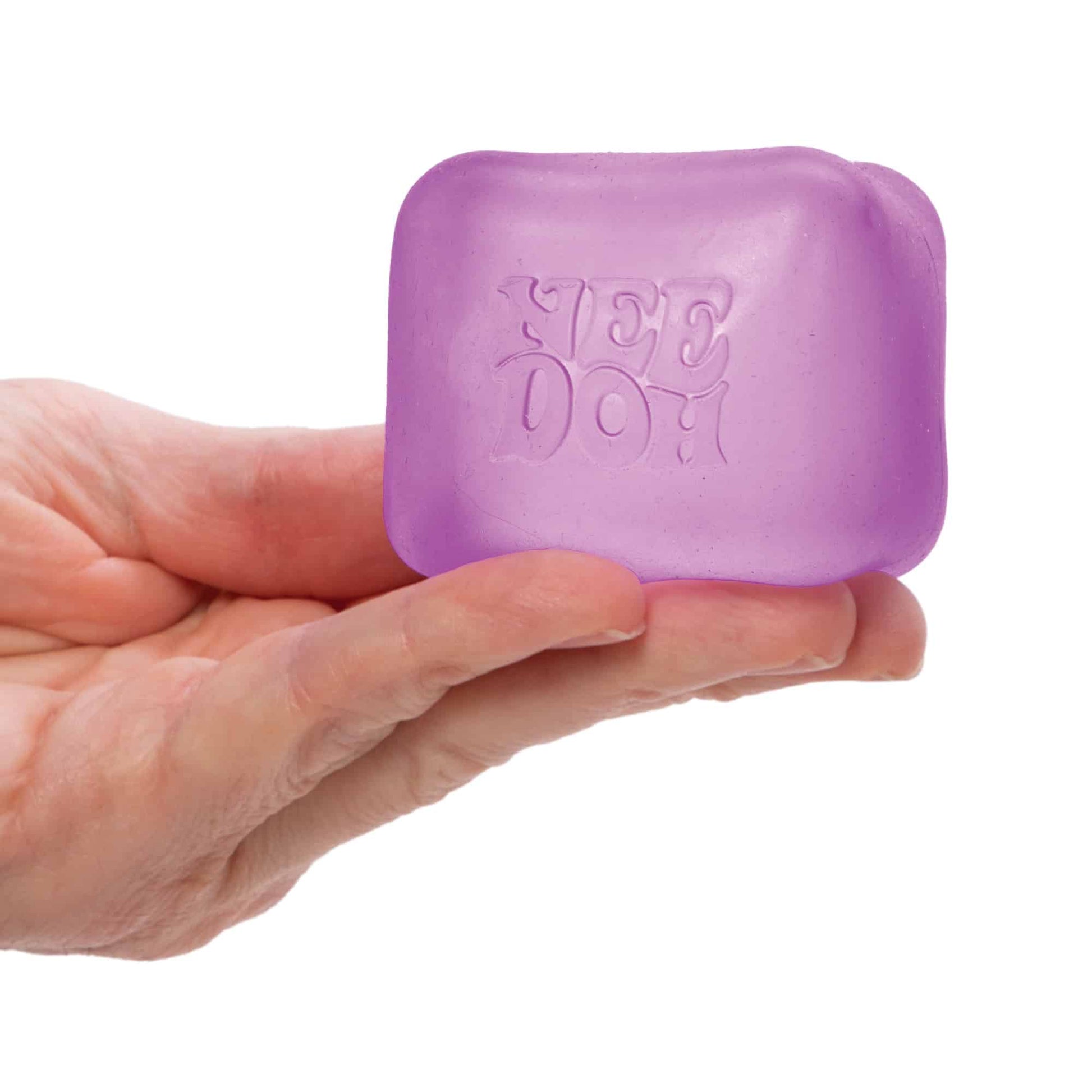Hand squeezing the purple NeeDoh Nice Cube stress ball, showing its satisfying squishy texture and compact size